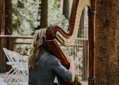 Leigh Brown performing with her harp at a wedding